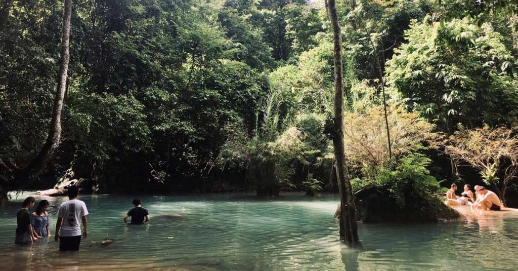 Tourists in Laos at Kuang Si Waterfall