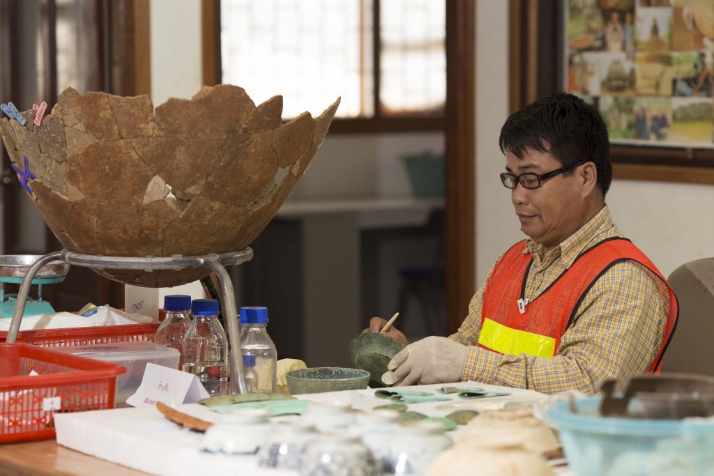 An archaeologist studying and preserving potteries, bronze bowl, bronze plates, bronze axes, and other ancient artifacts uncovered at Sepon mine through partnership between LXML; Ministry of Information, Culture and Information; National University of Laos; and James Cook University of Australia since 2008.