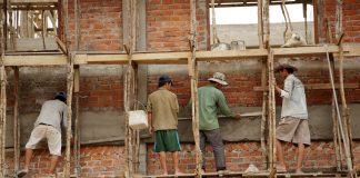 Laborers work on a new school building in Luang Prabang Province, Northern Laos.