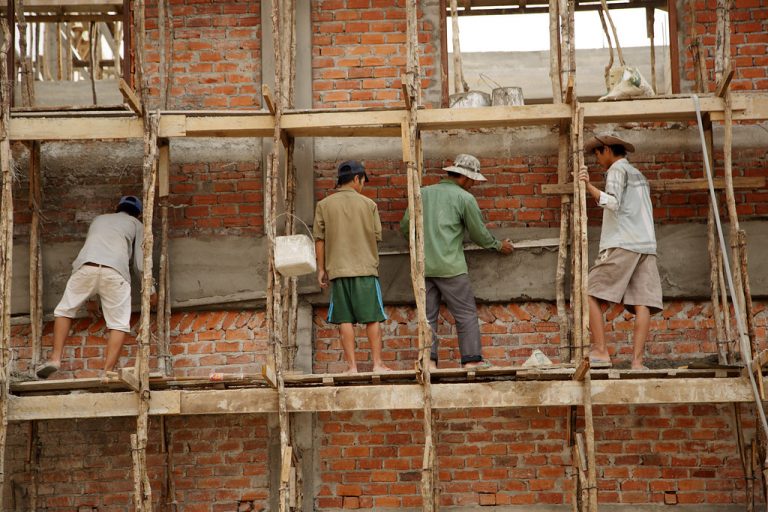 Laborers work on a new school building in Luang Prabang Province, Northern Laos.