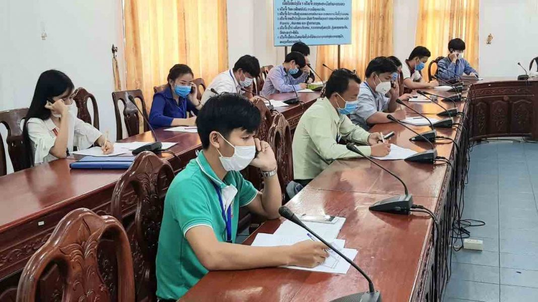 Hotline Call Center staff practice social distancing guidelines as they receive calls from the public 24 hour a day (Photo: CIEH MOH LAO)