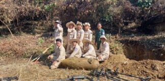 MAG team poses with UXO bomb