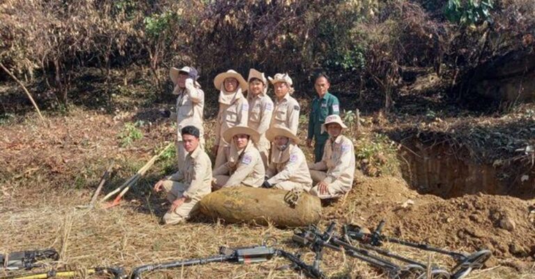 MAG team poses with UXO bomb