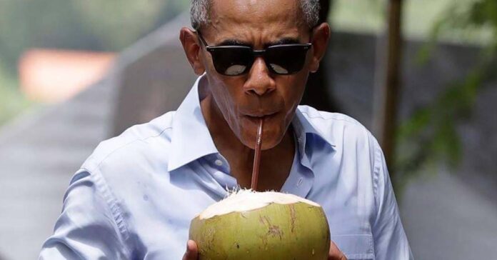Obama drinks coconut water in Luang Prabang