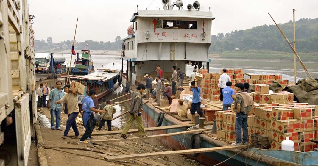 Cargo is offloaded from a boat in Houay Xai