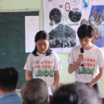 Zero Waste Laos volunteers speak to villagers about the harmful effects of open burning