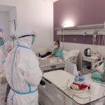 Members of a team of Chinese medical experts visit Covid-19 patients in Laos