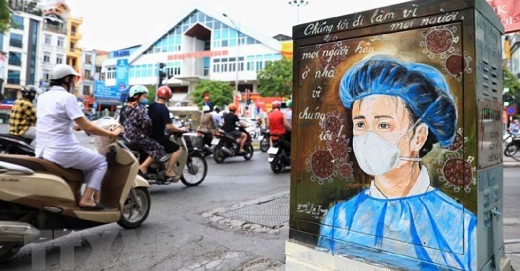 Scene from Vietnam depicting frontline medical worker, calling on people to stay at home (Photo: VNA)