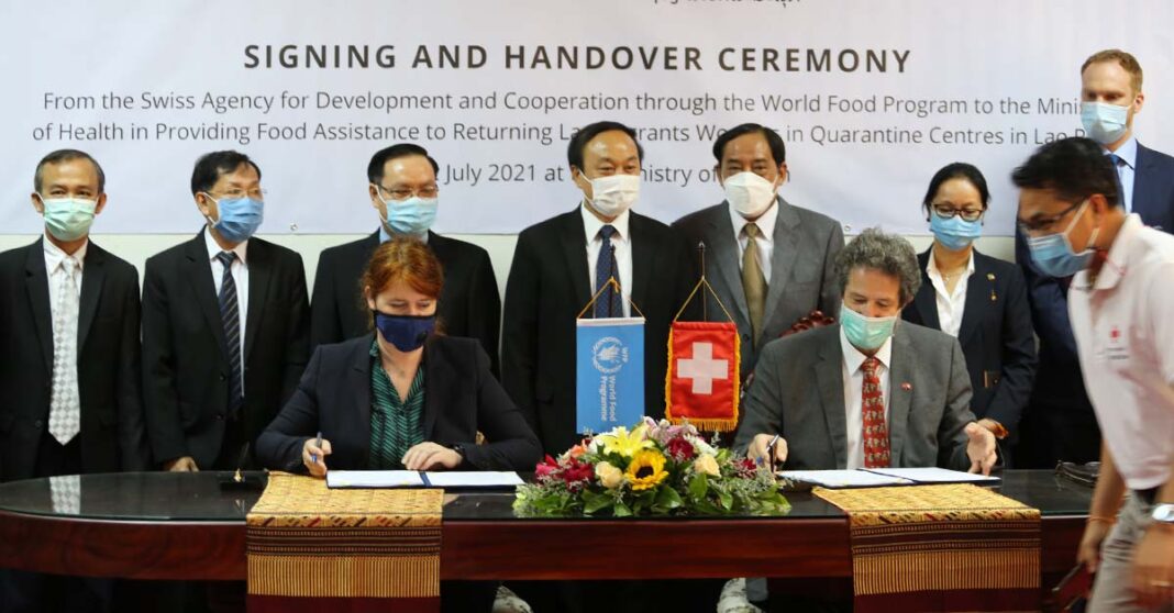 Officials from the Lao Government, SDC, and WFP attend the signing ceremony on Monday