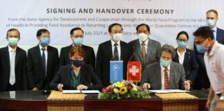 Officials from the Lao Government, SDC, and WFP attend the signing ceremony on Monday