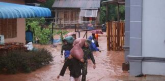 Military personnel assist villagers in flooded Luang Namtha