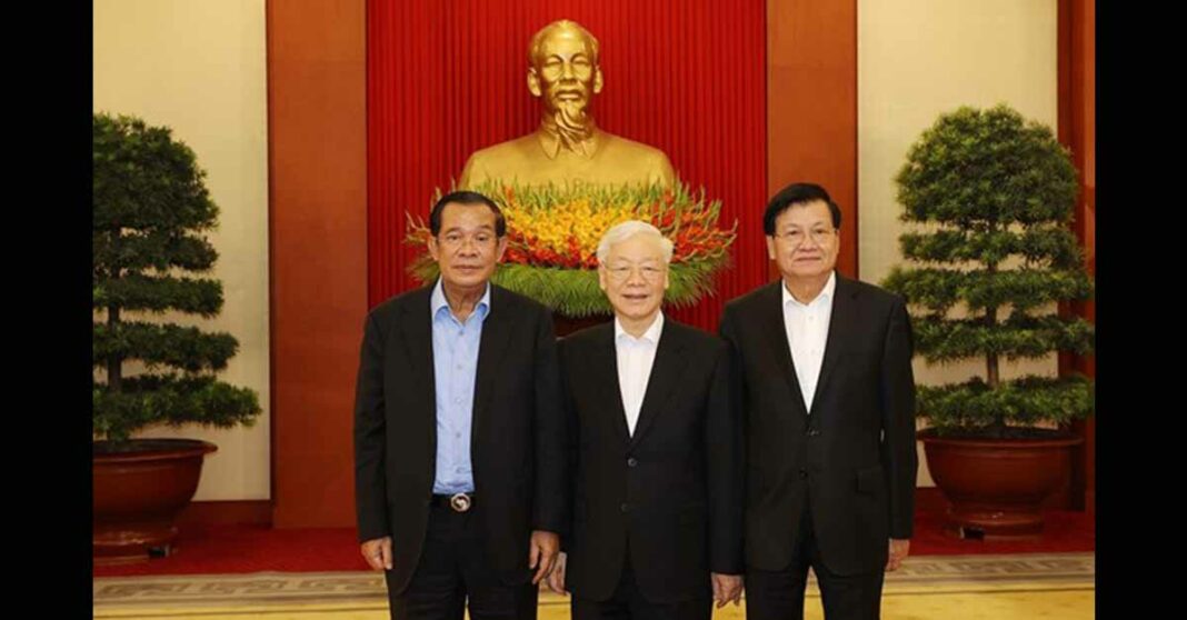 Lao President Thongloun Sisoulith poses with Vietnamese and Cambodian leaders in Hanoi.