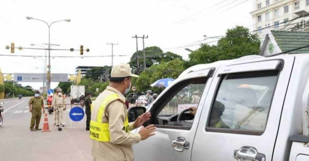 Police stop a motorist during Vientiane lockdown