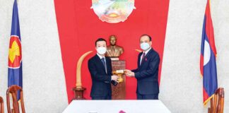 Chairman of Prince Holding Group hands over a donation to the Lao Embassy in Cambodia.