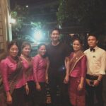 Wier Sukollawat stands next to Kualao staff outside of the restaurant