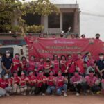 foodpanda employees and rescue personnel pose for a photograph after handing out happiness bags.