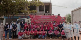 foodpanda employees and rescue personnel pose for a photograph after handing out happiness bags.