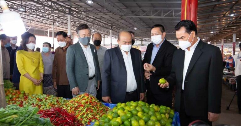 Officials sample goods at the Laos Wholesale-Retail Market