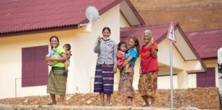 Resettled villagers in front of their new homes in Buam Or Village Luang Prabang