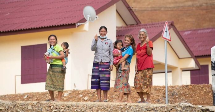 Resettled villagers in front of their new homes in Buam Or Village Luang Prabang