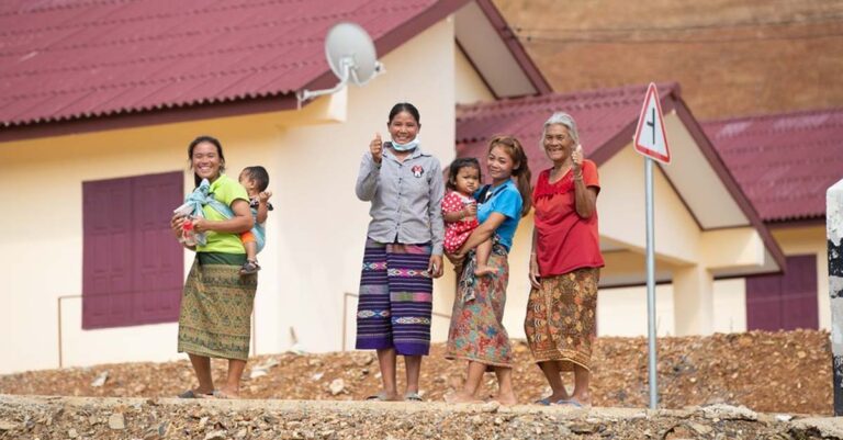 Resettled villagers in front of their new homes in Buam Or Village Luang Prabang