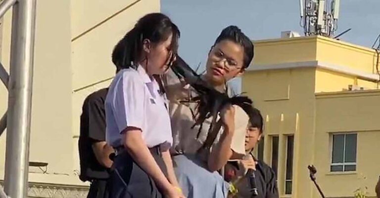 A teacher forcibly cuts a student's hair in Thailand.