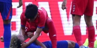 Lao player gives first aid to Cambodian at SEA Games