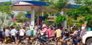 Motorbikes queue for petrol during the ongoing fuel crisis in Laos