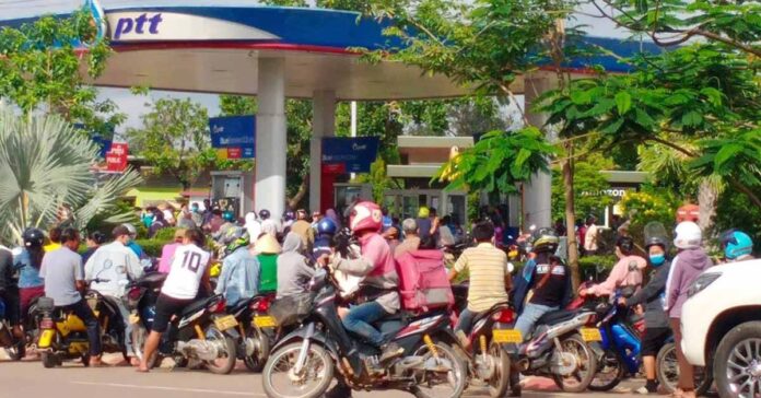 Motorbikes queue for petrol during the ongoing fuel crisis in Laos