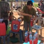 Motorists buy petrol in plastic bottles from roadside resellers(Photo: Channapha Kook).
