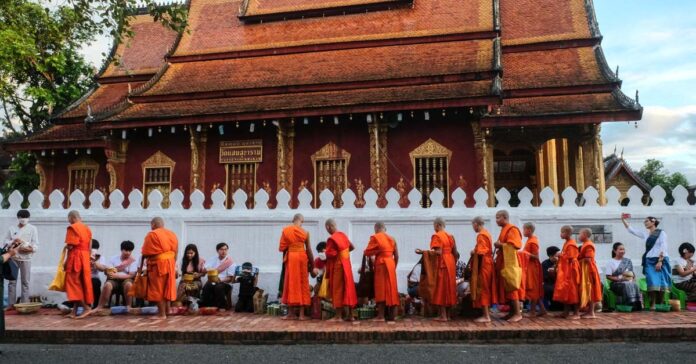 Locals and tourists alike participate in the morning almsgiving ceremony in Luang Prabang (Evensong Film)