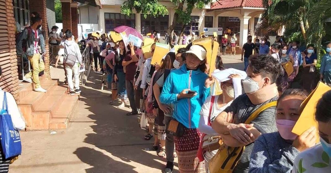 People in Laos line up to lodge passport applications at the consular department in Vientiane Capital