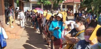 People in Laos line up to lodge passport applications at the consular department in Vientiane Capital