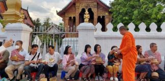 Thai tourists participate in a morning almsgiving ceremony in Luang Prabang (Photo - Ven. Bounhao Panyasouk)