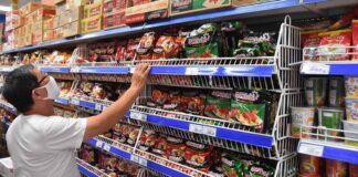 Customer browses instant noodles at a Vietnamese supermarket