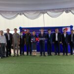 Minister of Labor and Social Welfare, Ms. Baykham Khattiya, receives pickup trucks on Wednesday from Japanese Ambassador to Laos, Mr. Kenichi Kobayashi.