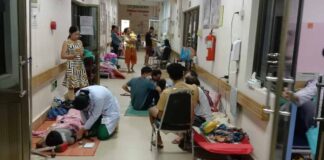 Patients at a children's hospital treated in a hallway after beds fill up during the dengue fever outbreak (Djoy Vatthanaphone).