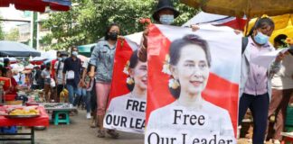 Protesters walk through a market with posters of ousted Myanmar leader Aung San Suu Kyi at Kamayut township in Yangon, Myanmar, on Apr 8, 2021. (File photo: AP)