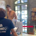 Shirtless tourist in Luang Prabang.