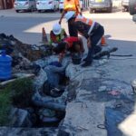 VCOMS workers attempting to unclog a drain in Vientiane Capital.