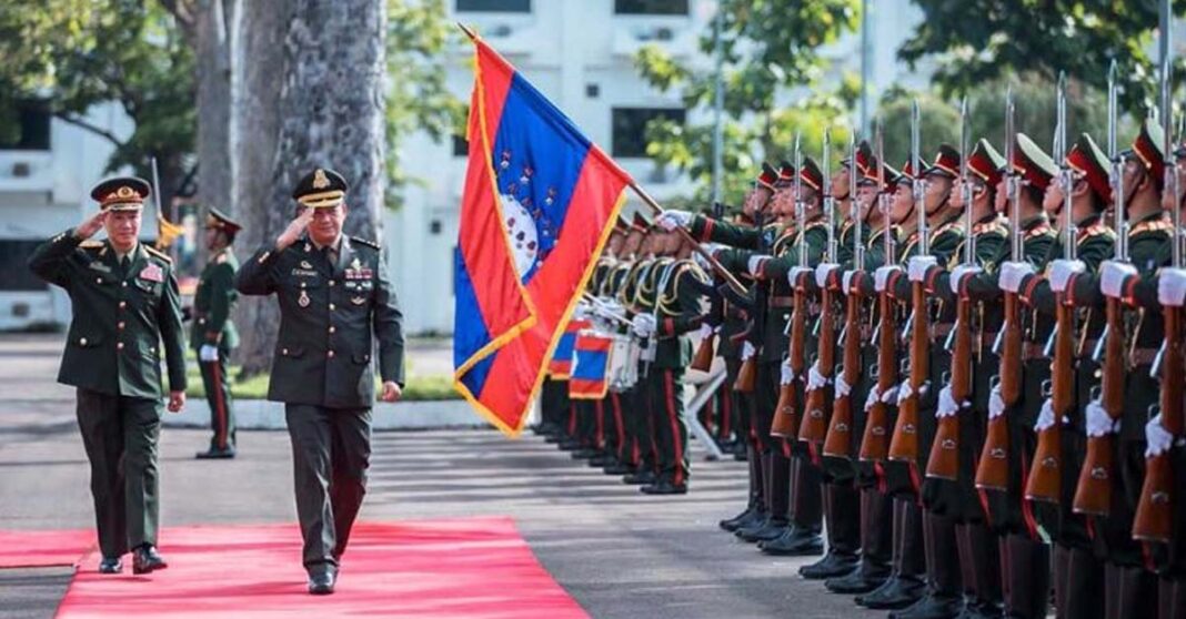 Lieutenant General Hun Manet and Khamliang Outhakaysone, Deputy Minister of National Defence and Chief of the General Staff of the Lao People’s Army, salute honour guards in Vientiane Capital on 30 August (HUN MANET VIA FACEBOOK).