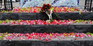 Petals are placed on Aremania monument outside the Kanjuruhan stadium to pay condolence to the victims of the stadium stampede.