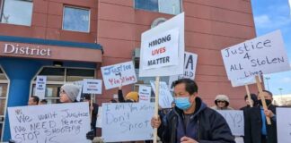 Demonstrators chant, "I'm deaf, don't shoot," as they march in front of the St. Paul Police Department's Western District office on Sunday, February 19, 2023. Credit: Simone Cazares | MPR News