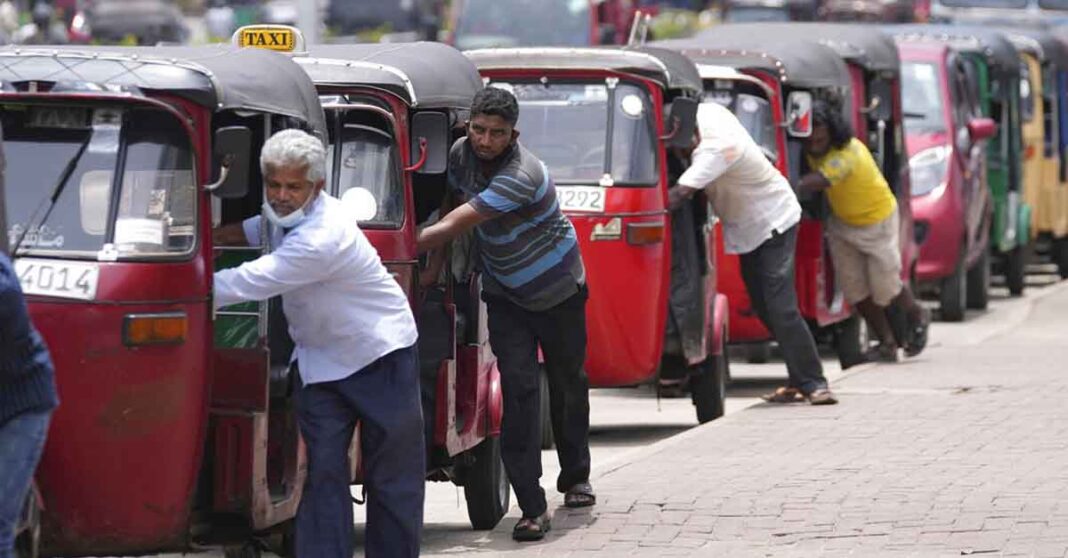 Auto rickshaw drivers line up to buy gas near a fuel station in Colombo, Sri Lanka, Wednesday, April 13, 2022. AP Photo/Eranga Jayawardena, File)