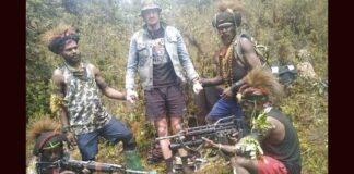 In this undated photo released by West Papua Liberation Army, the armed wing of the Free Papua Movement, Papuan separatist rebels pose for a photo with a man they said is New Zealander pilot Phillip Mark Mehrtens who they took hostage last week, at an undisclosed location in Papua province, Indonesia. Mehrtens, a pilot for Indonesian aviation company Susi Air, was abducted by the independence fighters who stormed his single-engine plane shortly after it landed on a small runway in Paro in remote Nduga district. (West Papua Liberation Army via AP)