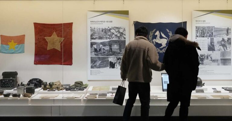 Visitors watch records of South Korean military soldiers during the Vietnam War at the War Memorial of Korea in Seoul, South Korea, Friday, Feb. 17, 2023