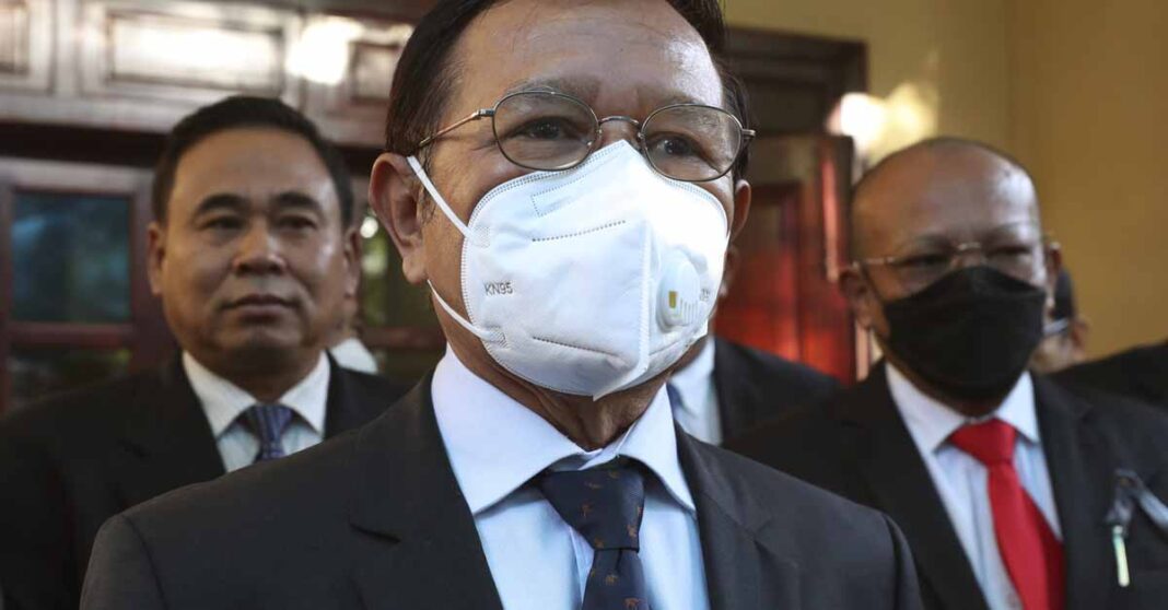 FILE - Cambodia National Rescue Party's President Kem Sokha, center, speaks to journalists before heading to the court in his house in Phnom Penh, Cambodia, on Jan. 19, 2022. Kem Sokha, Cambodia's most prominent opposition politician not in exile, is scheduled Friday, March 3, 2023, to hear the verdict in his trial for treason, for which he was arrested in 2017 as part of a government crackdown on the opposition. (AP Photo/Heng Sinith, File)