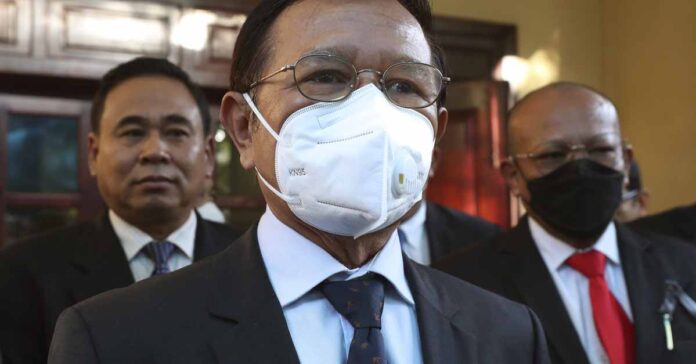 FILE - Cambodia National Rescue Party's President Kem Sokha, center, speaks to journalists before heading to the court in his house in Phnom Penh, Cambodia, on Jan. 19, 2022. Kem Sokha, Cambodia's most prominent opposition politician not in exile, is scheduled Friday, March 3, 2023, to hear the verdict in his trial for treason, for which he was arrested in 2017 as part of a government crackdown on the opposition. (AP Photo/Heng Sinith, File) FILE - Cambodia National Rescue Party's President Kem Sokha, center, speaks to journalists before heading to the court in his house in Phnom Penh, Cambodia, on Jan. 19, 2022. Kem Sokha, Cambodia's most prominent opposition politician not in exile, is scheduled Friday, March 3, 2023, to hear the verdict in his trial for treason, for which he was arrested in 2017 as part of a government crackdown on the opposition. (AP Photo/Heng Sinith, File)