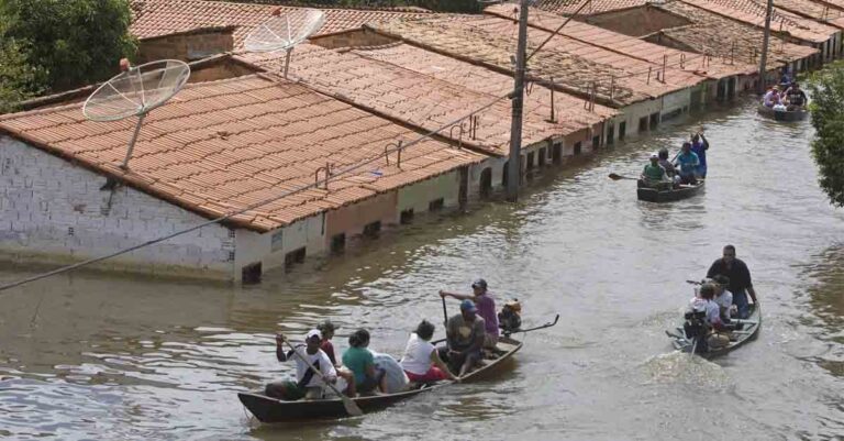 People travel by boat in a flooded street in Trizidela do Vale, state of Maranhao, Brazil, May 9, 2009. The intensity of extreme drought and rainfall has “sharply” increased over the past 20 years, according to a study published Monday, March 13, 2023, in the journal Nature Water. (AP Photo/ Andre Penner, File)