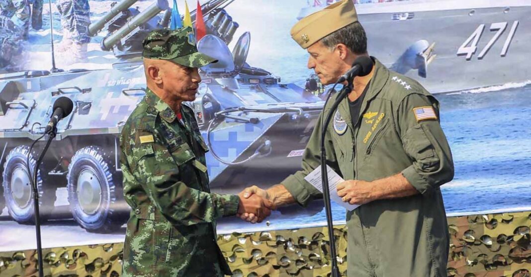 In this photo released by Royal Thai Army, Thailand Chief of Defence Forces General Chalermpol Srisawasdi, left, shakes hands with Commander of the United States Indo-Pacific Command Admiral John Aquilino, during opening ceremony of Cobra Gold 2023 in Rayong Province Thailand, Tuesday, Feb. 28, 2023. Thai and U.S. officials presided over the opening ceremony Tuesday of Cobra Gold 2023, one of the biggest joint multilateral military exercises in the world that pulls together the security interests of the United States and six Asian nations. (Royal Thai Army via AP)